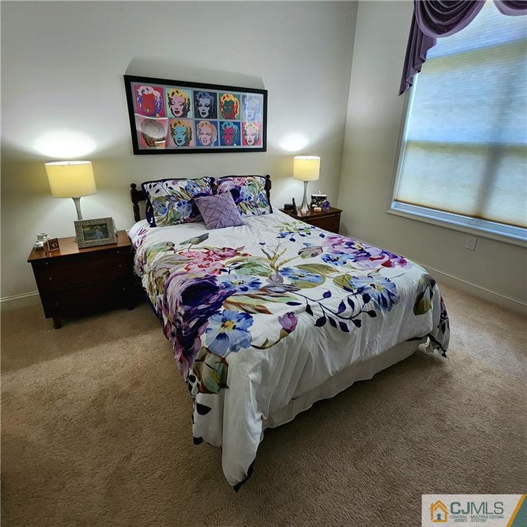 18 Mandrake Road Monroe Township, NJ 08831 - Photo 23 of 44 a bedroom with a bed and a lamp on dresser