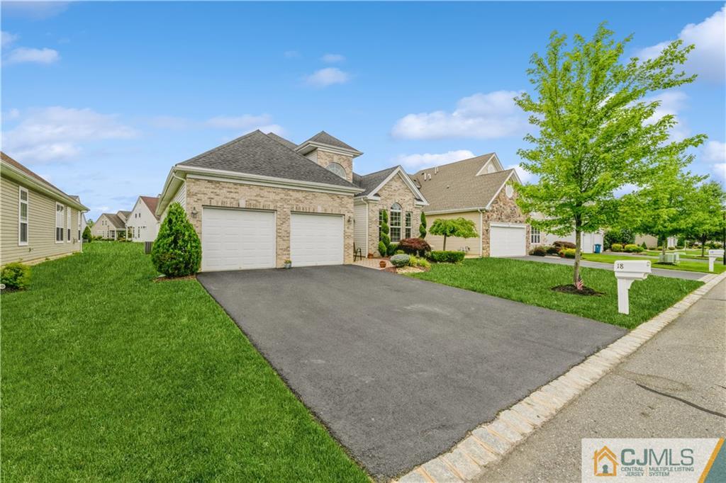 18 Mandrake Road Monroe Township, NJ 08831 - Photo 3 of 44 a front view of a house with a yard and garage