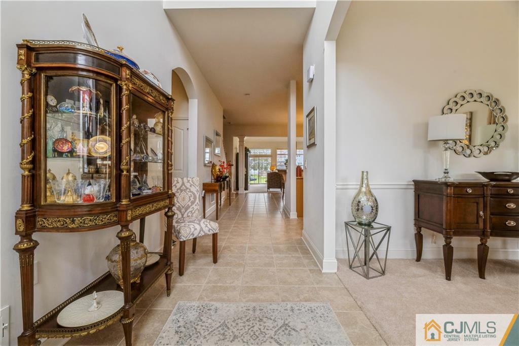 18 Mandrake Road Monroe Township, NJ 08831 - Photo 4 of 44 a view of a entryway with furniture and a mirror