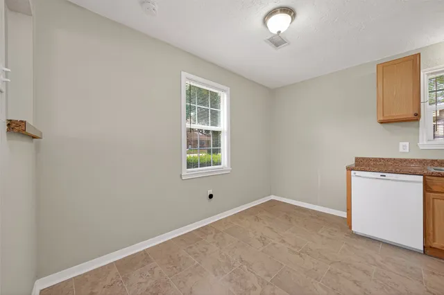 a kitchen with stainless steel appliances granite countertop a sink and cabinets