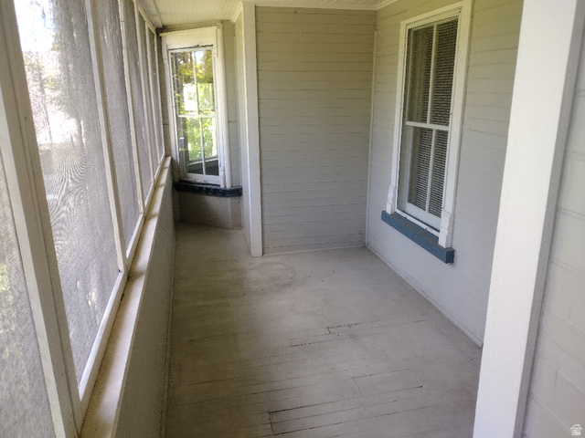 157 West 500 South Logan, UT 84321 - Photo 20 of 38 Screened porch featuring a painted wood floor, white wood-frame screens, and a tongue-and-groove ceiling