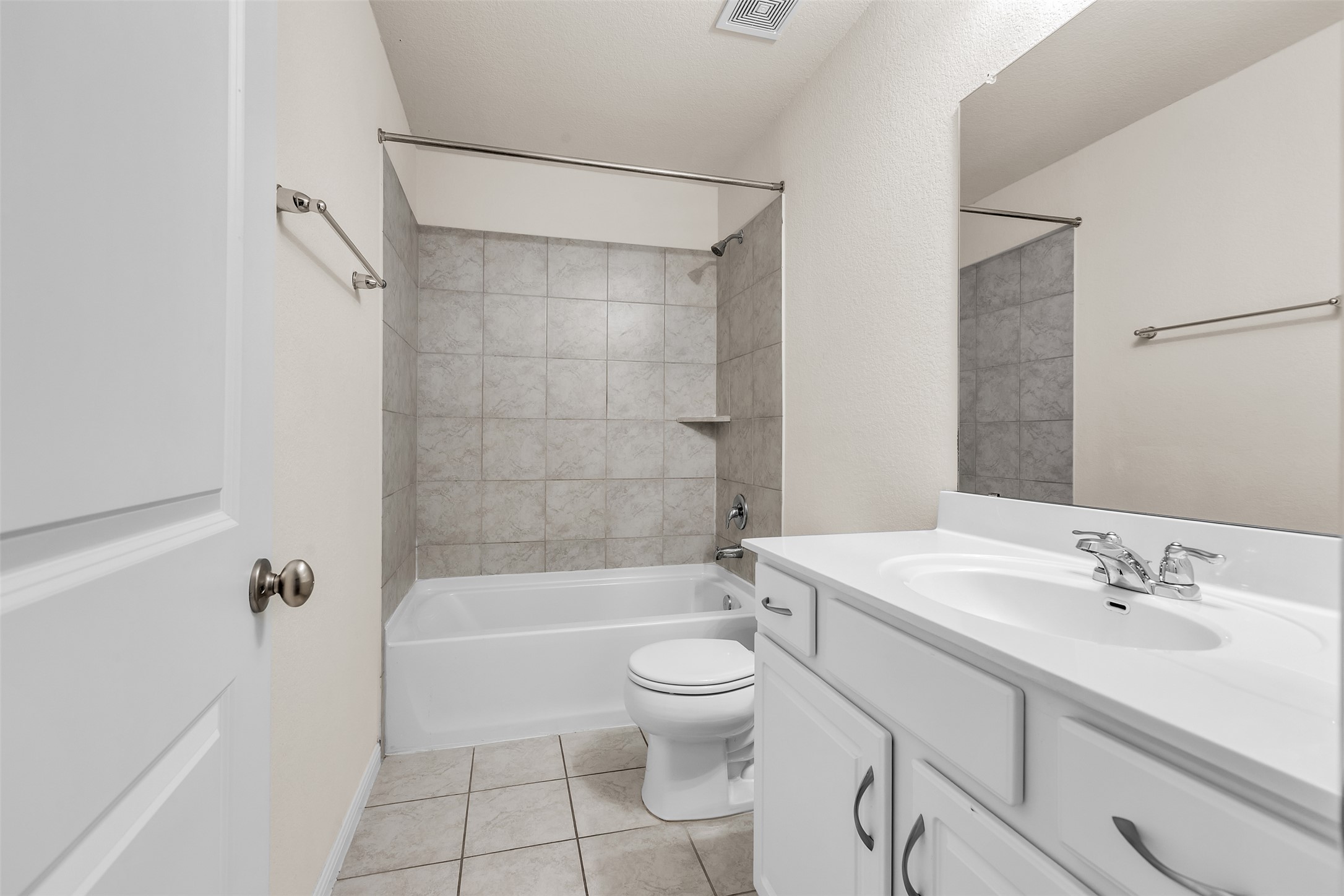 13014 Carswell Street Austin, TX 78754 - Photo 10 of 21 Bathroom with vanity, washtub / shower combination, and light tile patterned floors