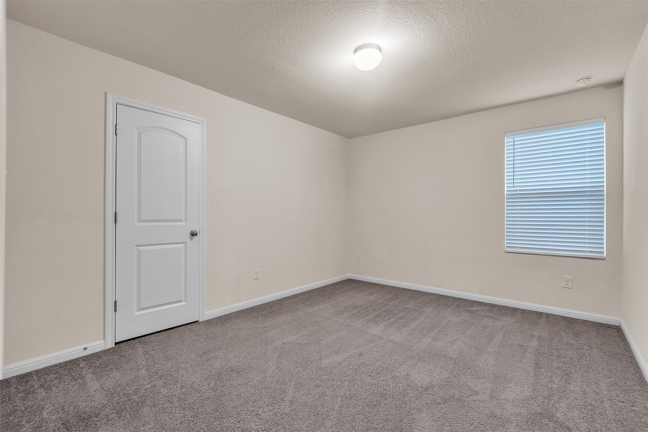 13014 Carswell Street Austin, TX 78754 - Photo 11 of 21 Spare room with light carpet and a textured ceiling