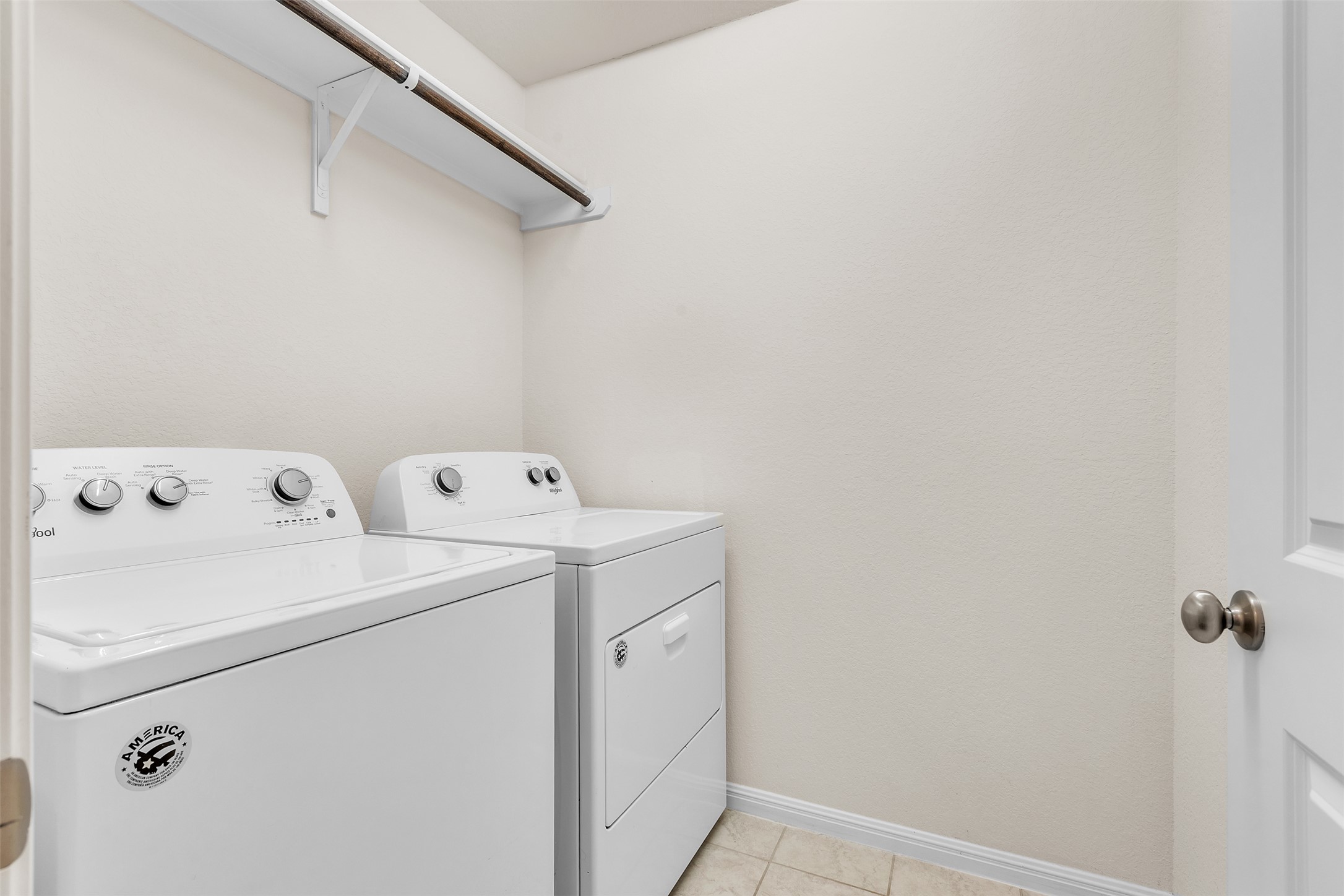 13014 Carswell Street Austin, TX 78754 - Photo 12 of 21 Laundry area featuring washing machine and dryer and light tile patterned floors