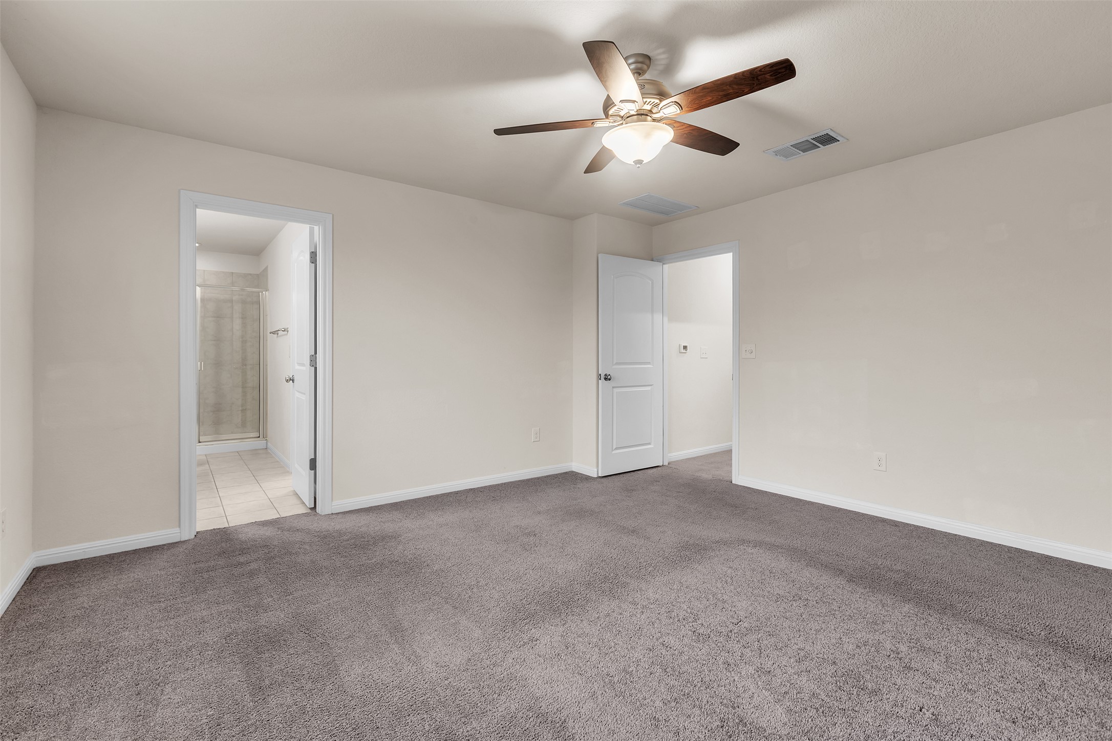 13014 Carswell Street Austin, TX 78754 - Photo 14 of 21 Unfurnished bedroom with light carpet, a ceiling fan, and ensuite bathroom