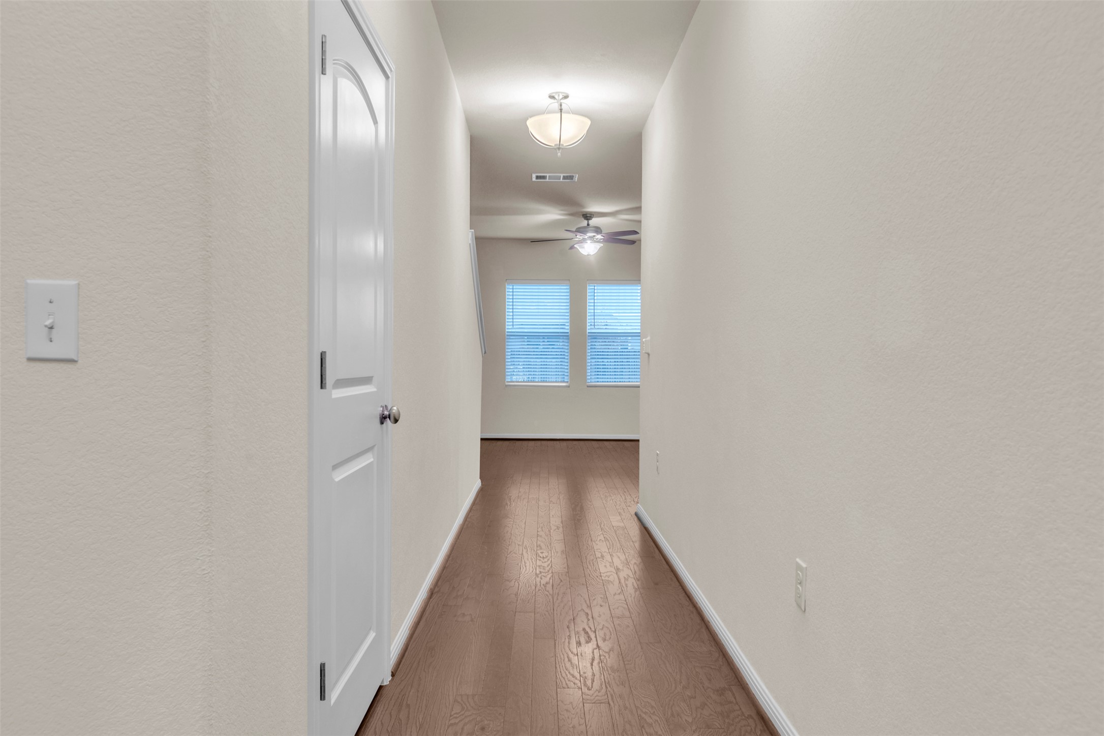 13014 Carswell Street Austin, TX 78754 - Photo 3 of 21 Hallway featuring wood-type flooring and baseboards