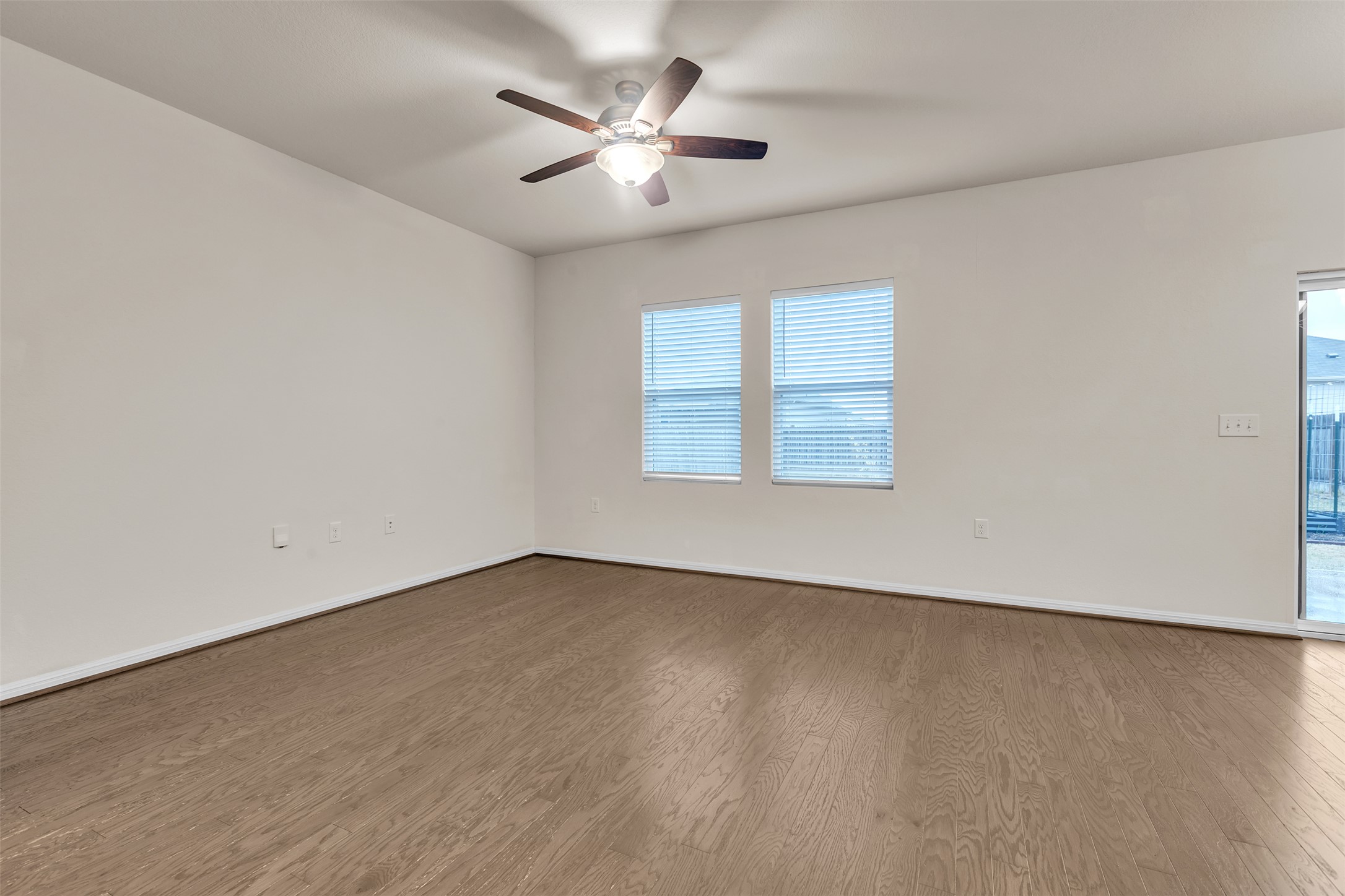 13014 Carswell Street Austin, TX 78754 - Photo 5 of 21 Unfurnished room featuring wood finished floors and ceiling fan