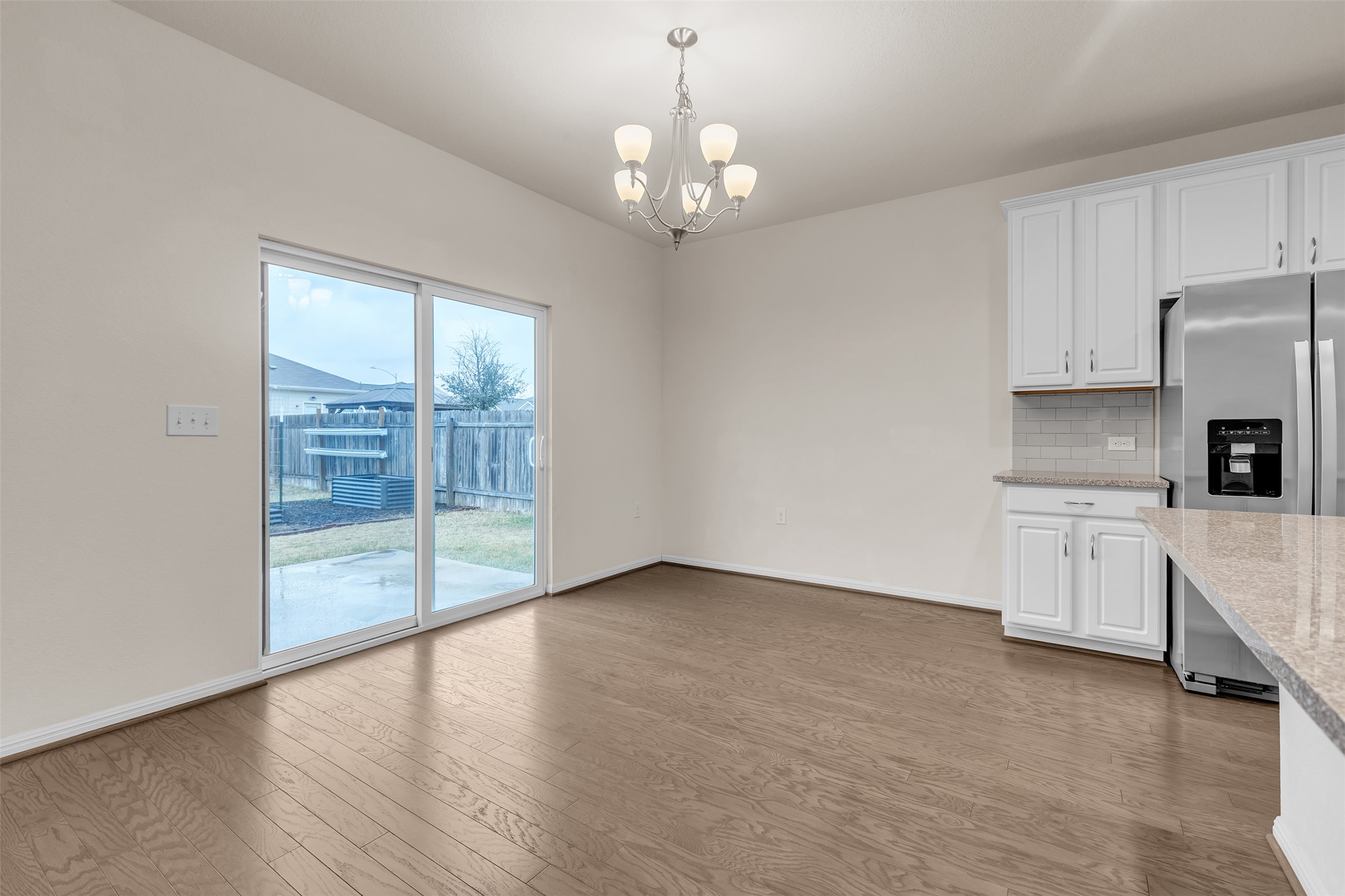 13014 Carswell Street Austin, TX 78754 - Photo 6 of 21 Unfurnished dining area featuring suspended lighting and light wood finished floors