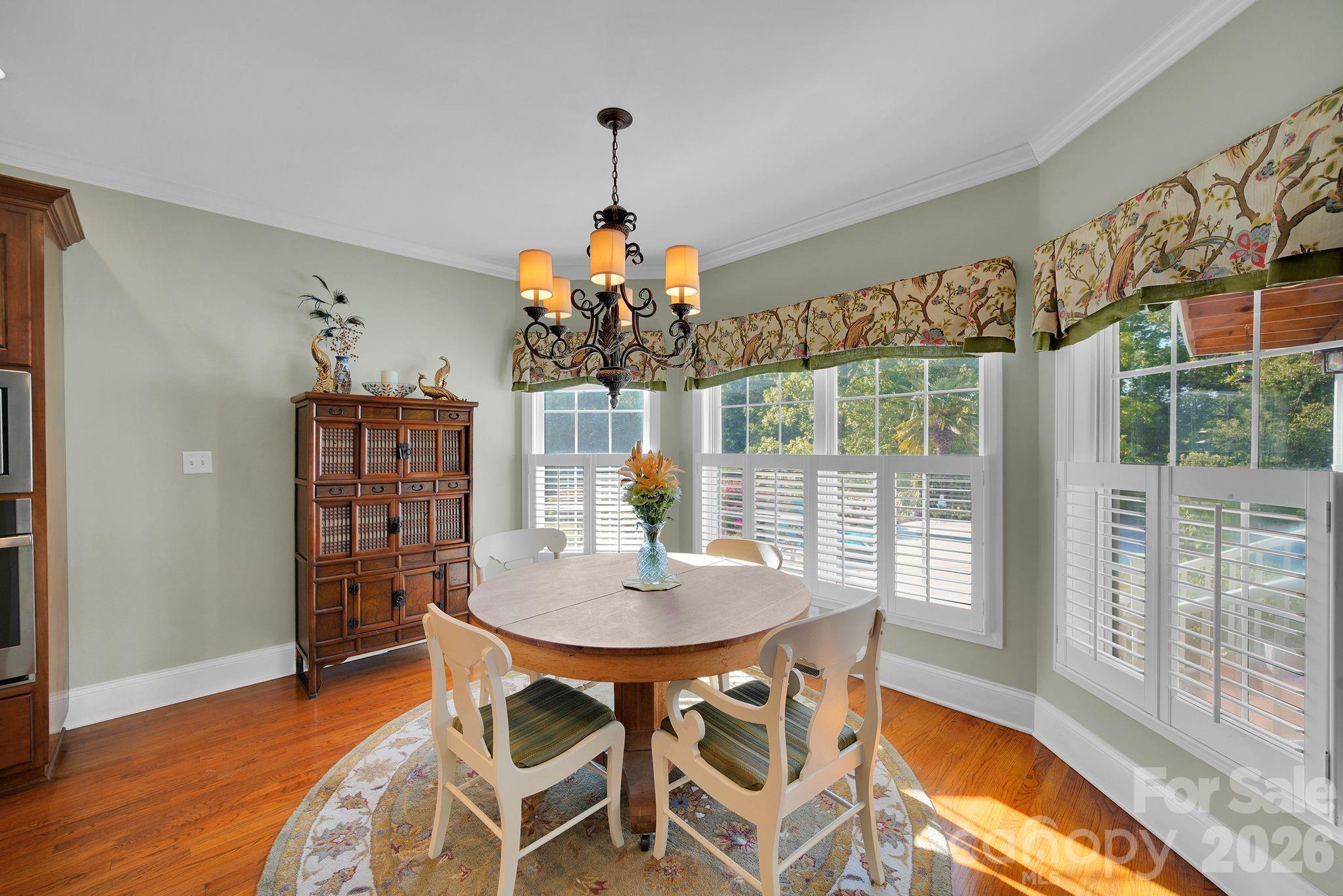 1171 State Rd S-29-376 Lancaster, SC 29720 - Photo 17 of 48 a dining room with furniture a chandelier and wooden floor