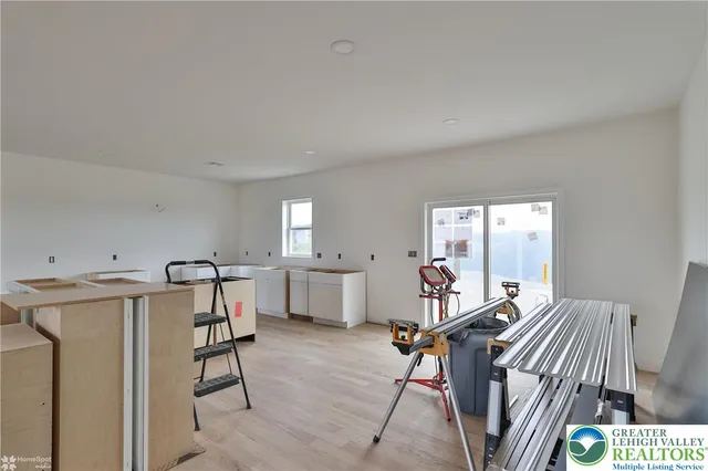 an empty room with wooden floor and window
