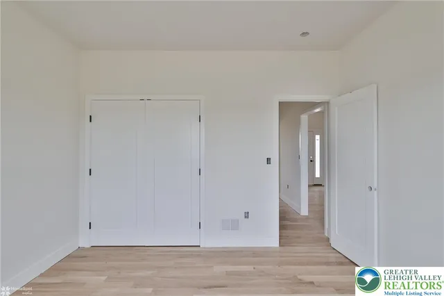a view of empty room with wooden ceiling