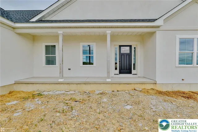 a view of empty room with wooden floor and window