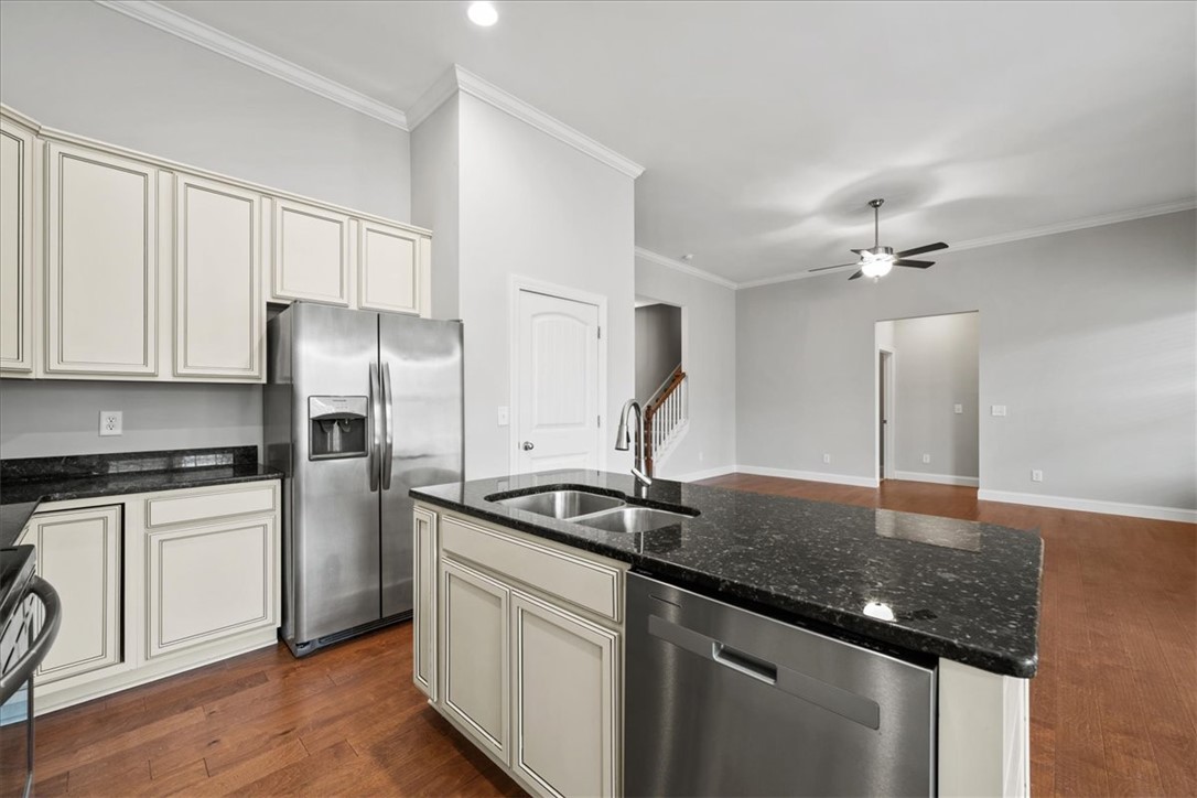 102 Ripplestone Way Anderson, SC 29621 - Photo 9 of 39 A contemporary kitchen space boasts sleek appliances and dark granite countertops.