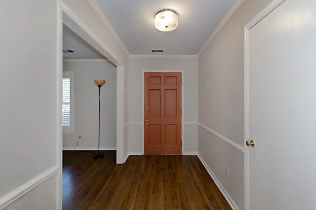 a view of a hallway with wooden floor