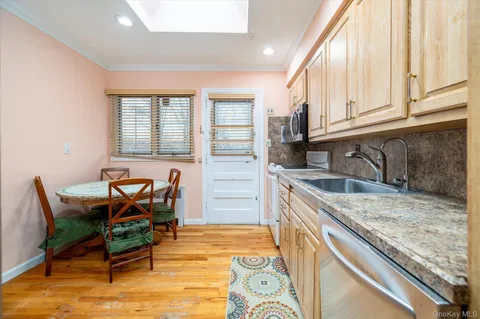 a kitchen with granite countertop a sink and a stove top oven