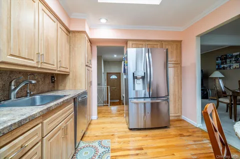 a kitchen with stainless steel appliances granite countertop a refrigerator and a sink