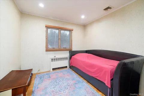 a bedroom with a bed and a chair