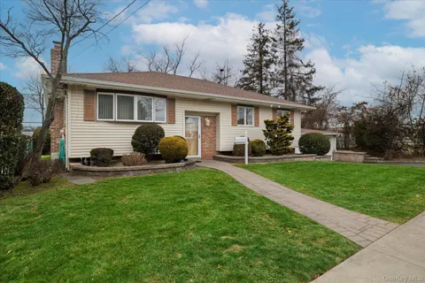 a front view of house with yard and green space