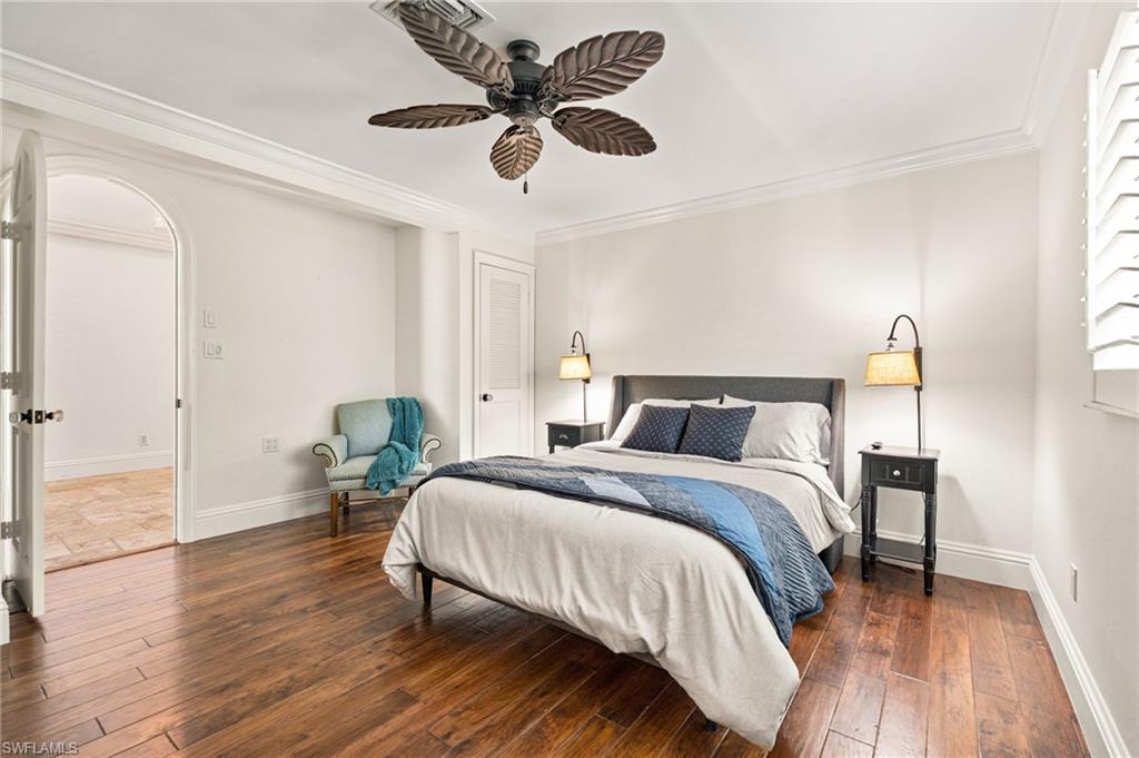 2201 Beacon Lane Naples, FL 34103 - Photo 19 of 25 a bedroom with a bed and wooden floor