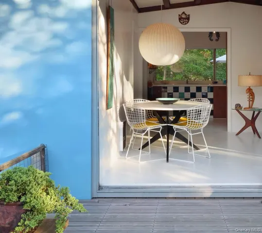a dining room with furniture and a mirror