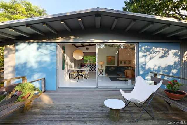 a view of a porch with furniture and a yard