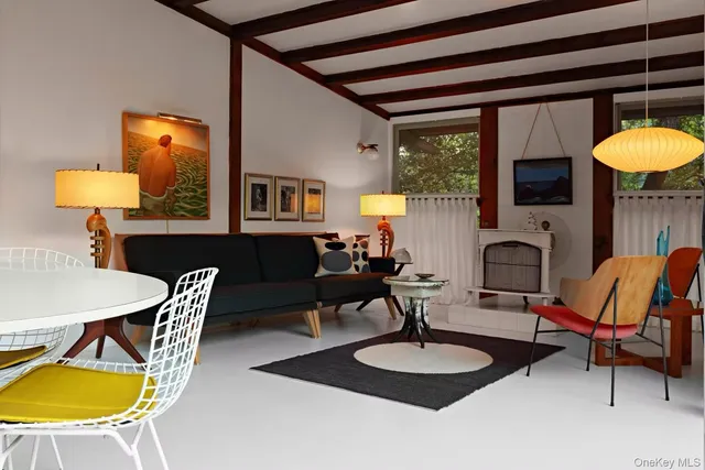 a living room with furniture a fireplace and a chandelier