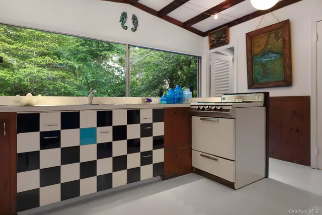 a kitchen with a stove a sink and a microwave