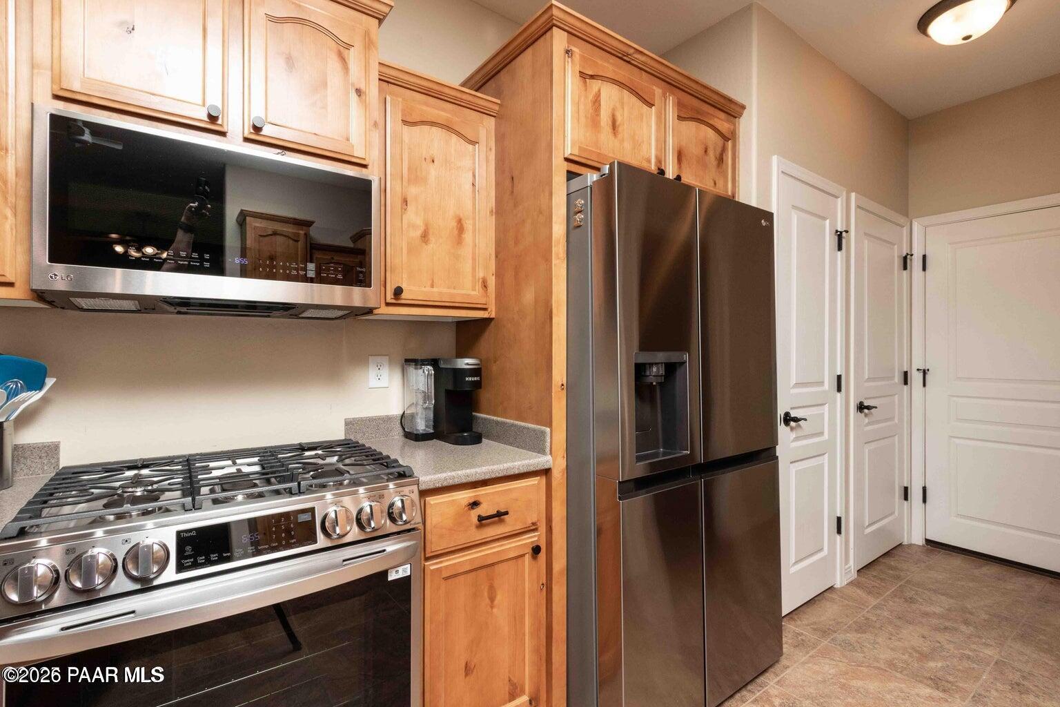 12933 Ponce Street Dewey, AZ 86327 - Photo 12 of 41 a kitchen with stainless steel appliances granite countertop a refrigerator stove and microwave
