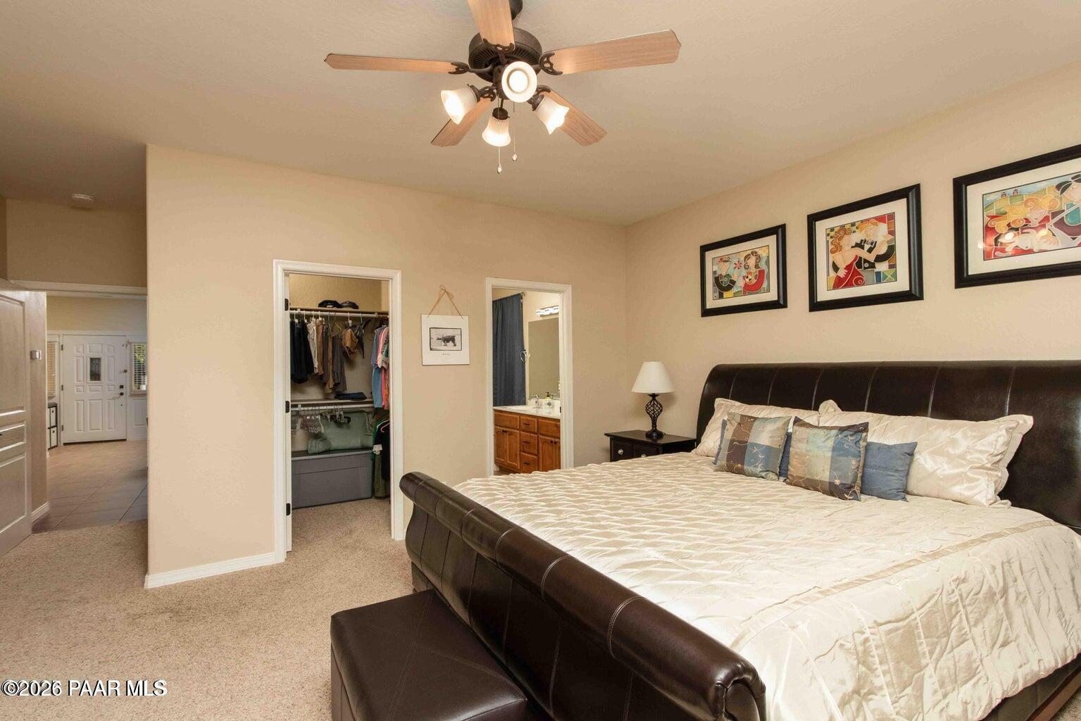 12933 Ponce Street Dewey, AZ 86327 - Photo 14 of 41 a bedroom with a large bed and a chandelier