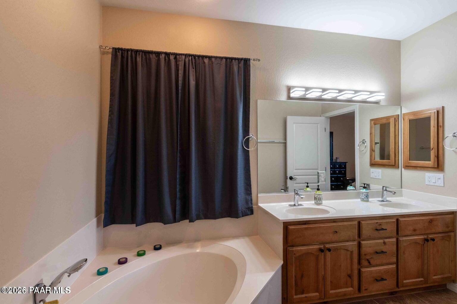 12933 Ponce Street Dewey, AZ 86327 - Photo 17 of 41 a bathroom with a double vanity sink and mirror