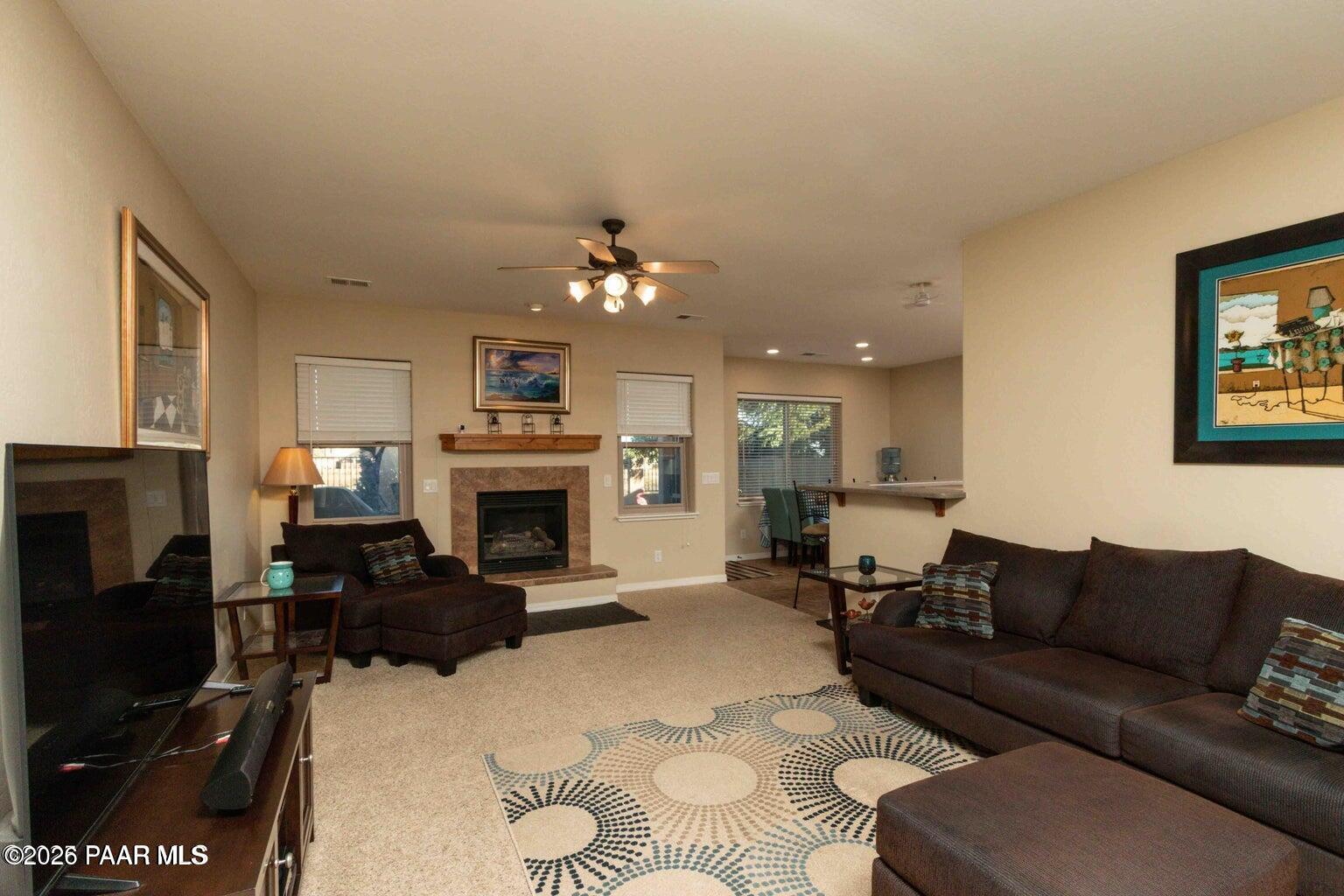 12933 Ponce Street Dewey, AZ 86327 - Photo 6 of 41 a living room with furniture a fireplace and a flat screen tv
