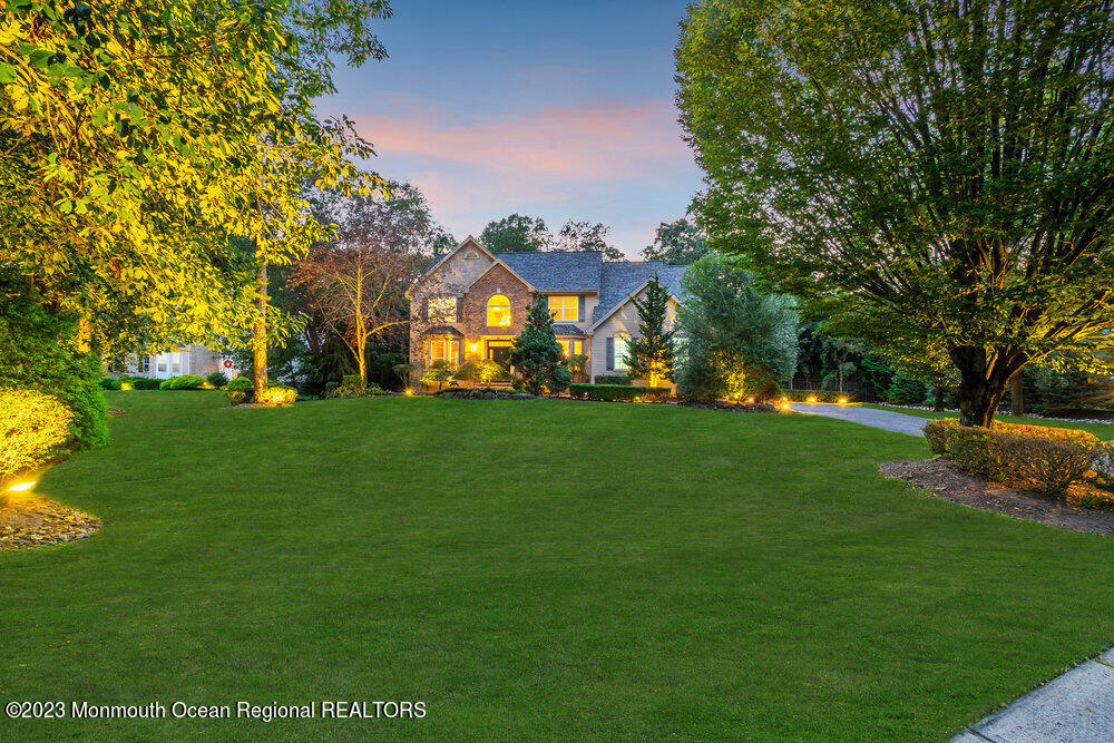 30 Erin Drive Jackson, NJ 08527 - Photo 102 of 105 a front view of a house with garden and trees
