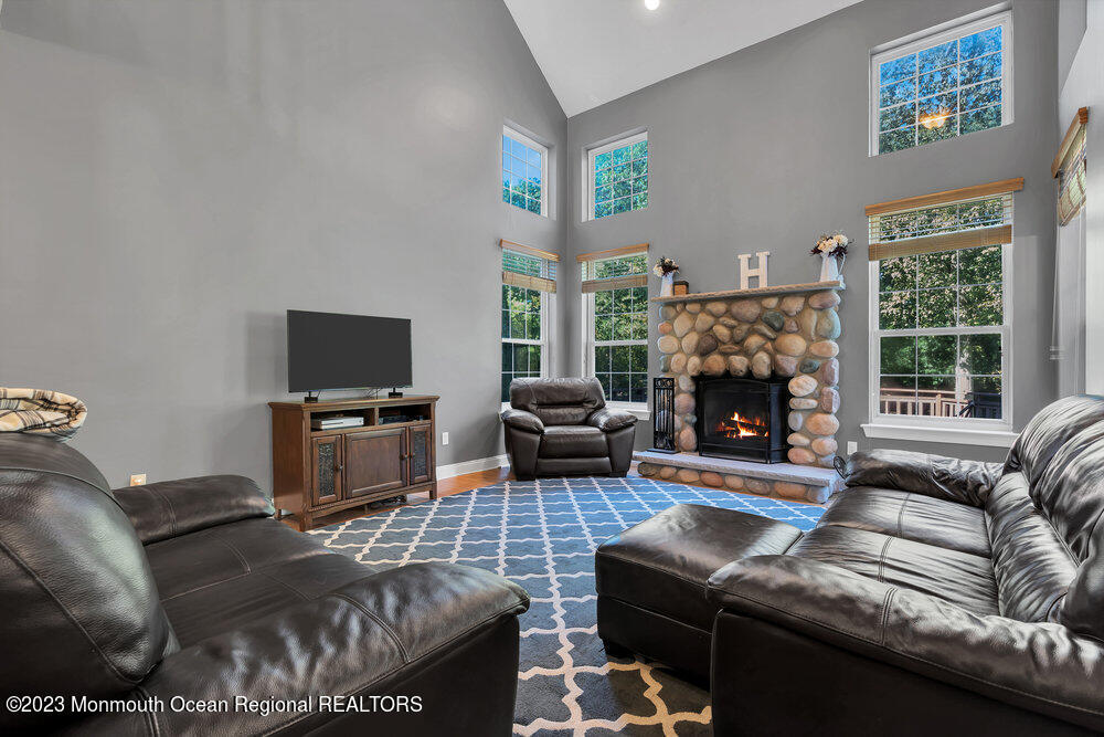 30 Erin Drive Jackson, NJ 08527 - Photo 25 of 105 a living room with furniture a flat screen tv and a fireplace