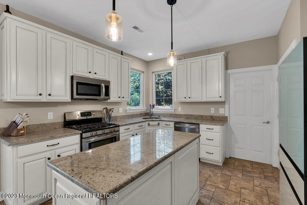 30 Erin Drive Jackson, NJ 08527 - Photo 32 of 105 a kitchen with granite countertop stainless steel appliances a stove sink microwave and cabinets