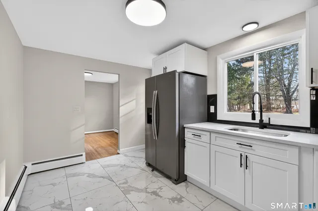 a kitchen with stainless steel appliances granite countertop a refrigerator and a sink