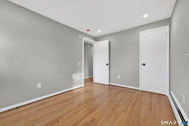 a view of hallway with wooden floor