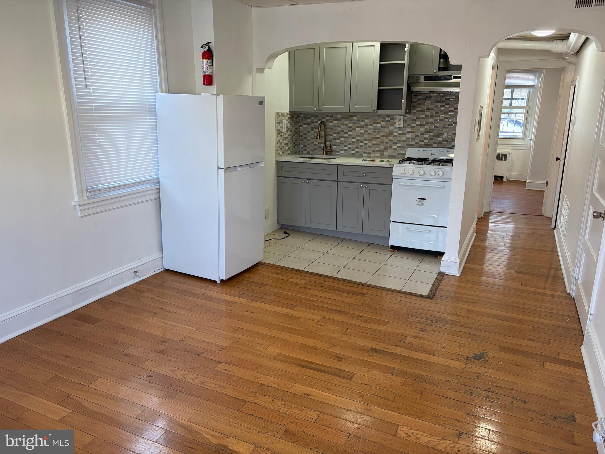 a kitchen with granite countertop a refrigerator and a sink