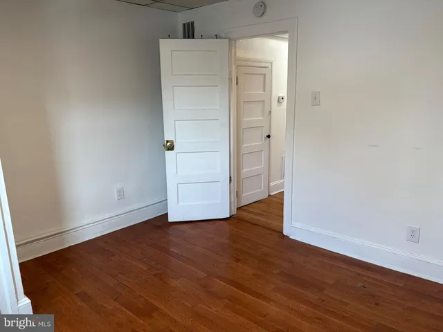 an empty room with wooden floor