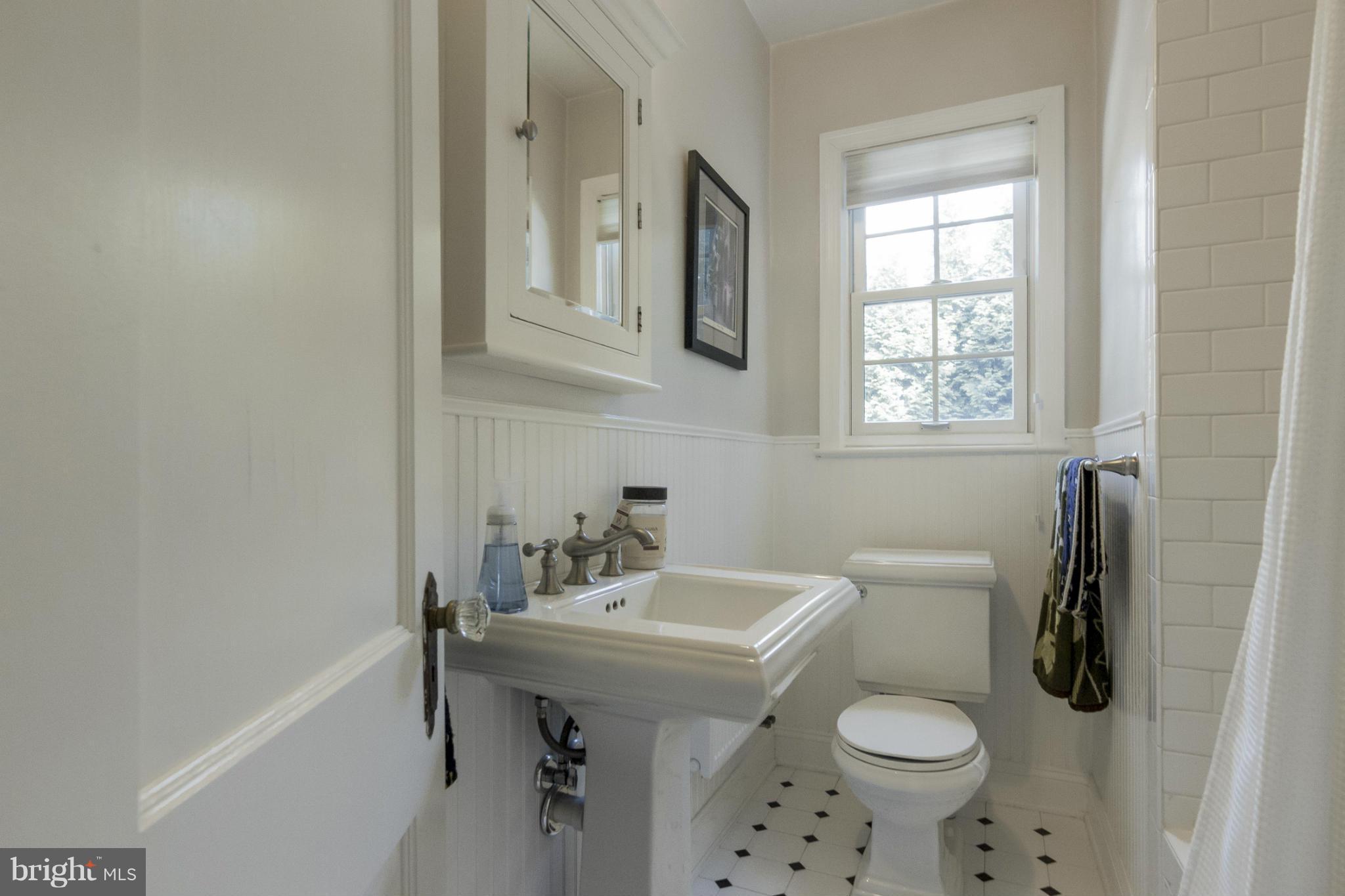 9921 Rogart Road Silver Spring, MD 20901 - Photo 13 of 30 a bathroom with a sink toilet and shower