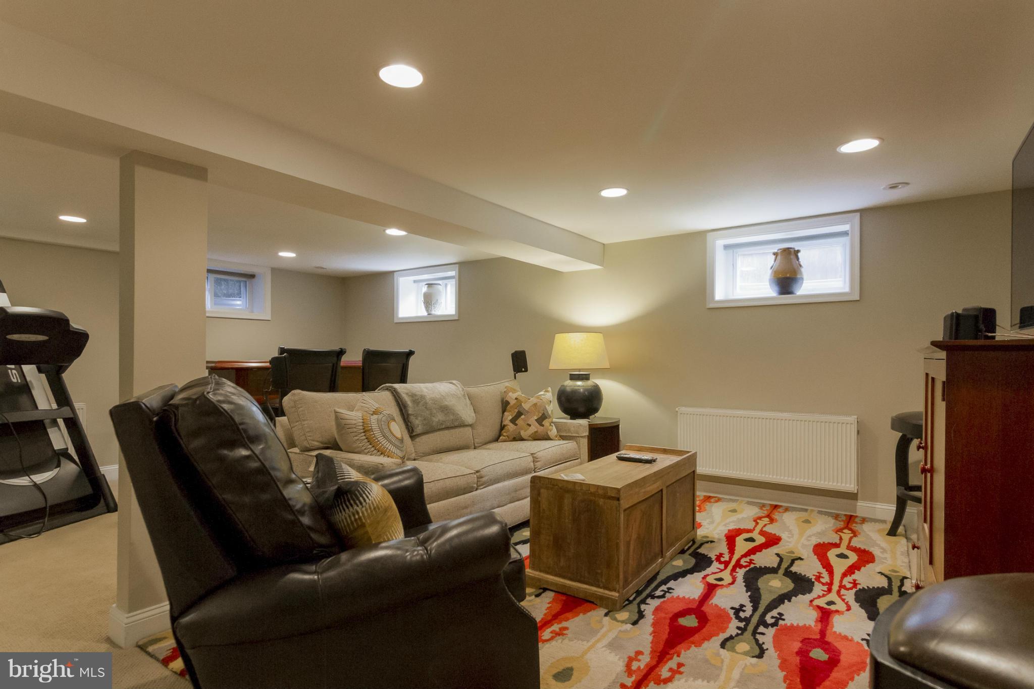 9921 Rogart Road Silver Spring, MD 20901 - Photo 20 of 30 a living room with furniture and a flat screen tv