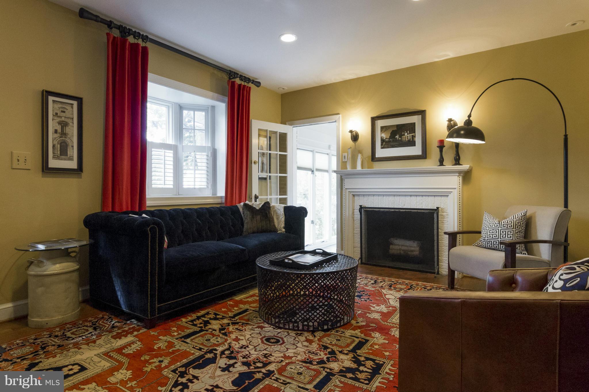 9921 Rogart Road Silver Spring, MD 20901 - Photo 3 of 30 a living room with furniture a window and a fireplace