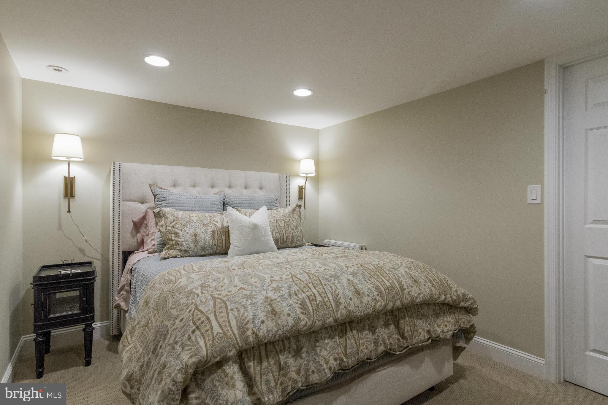 9921 Rogart Road Silver Spring, MD 20901 - Photo 21 of 30 a bedroom with a bed and a view of bathroom