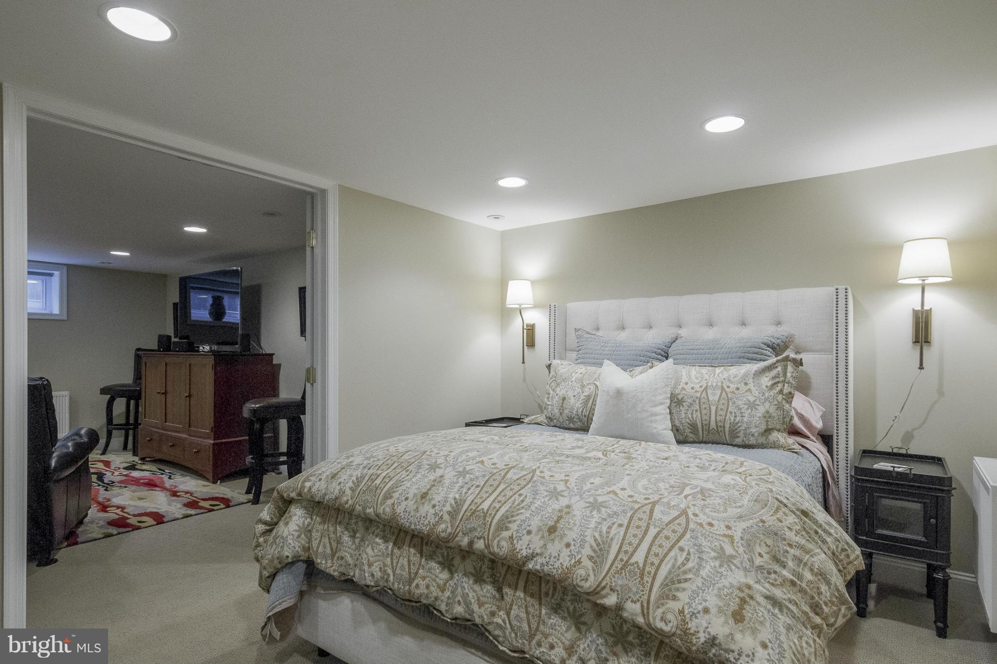 9921 Rogart Road Silver Spring, MD 20901 - Photo 22 of 30 a large bedroom with a bed and a desk in it