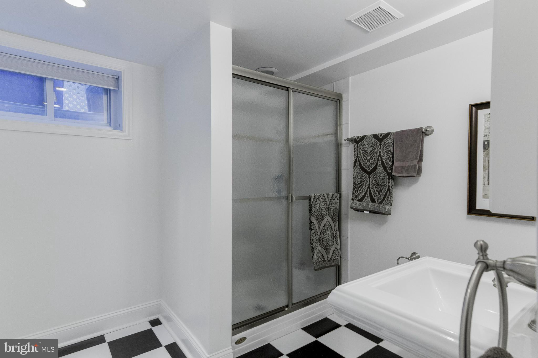 9921 Rogart Road Silver Spring, MD 20901 - Photo 23 of 30 a bathroom with a sink and a shower