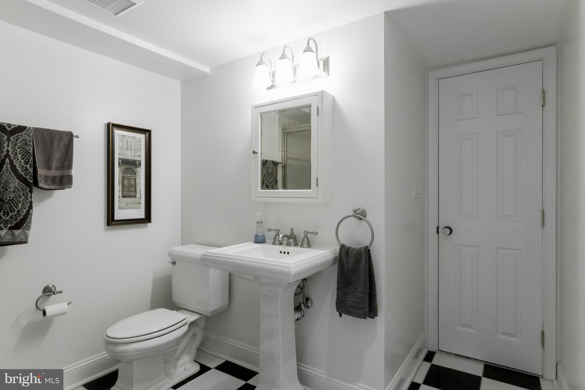 9921 Rogart Road Silver Spring, MD 20901 - Photo 24 of 30 a bathroom with a toilet sink and mirror