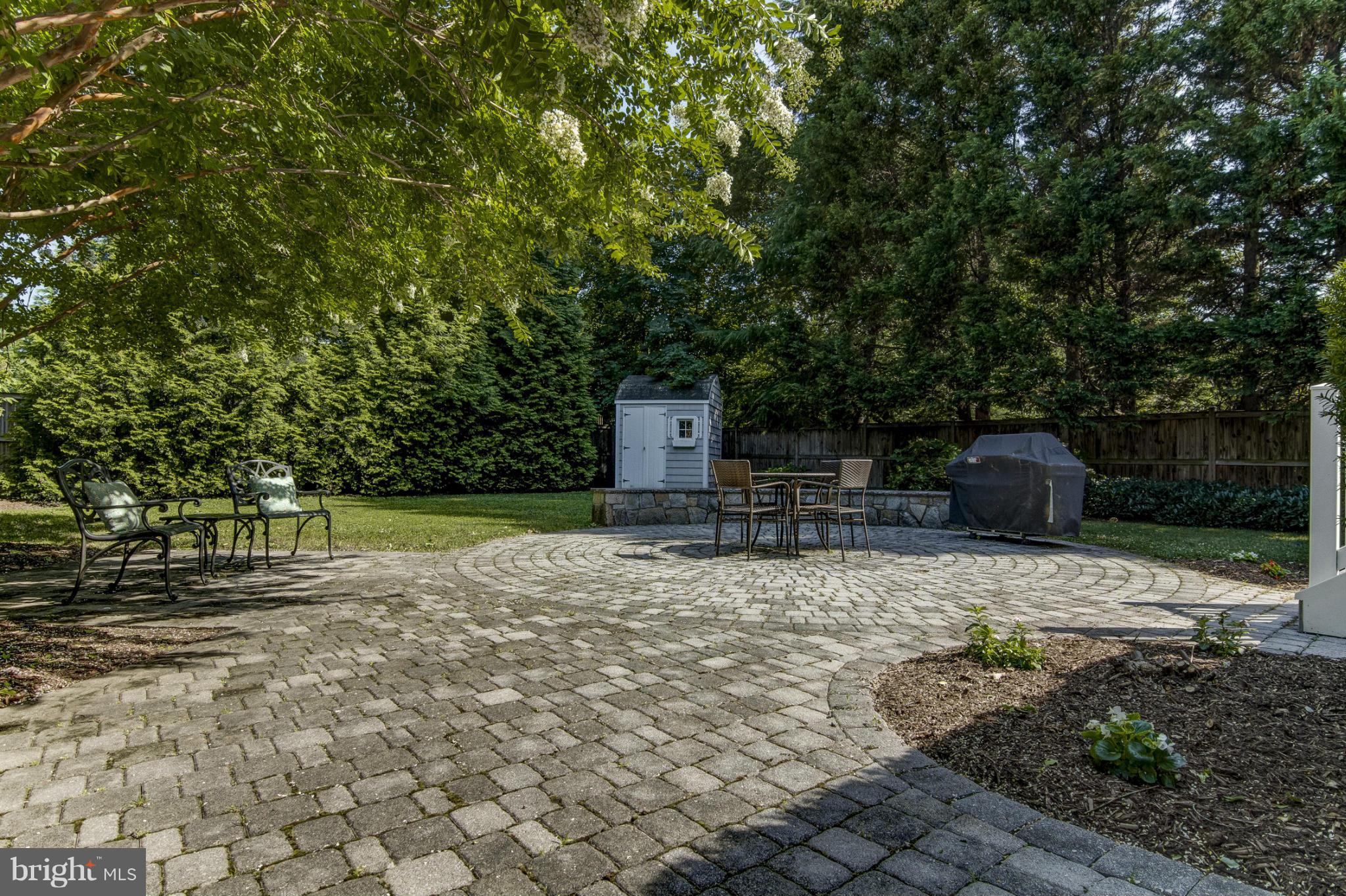 9921 Rogart Road Silver Spring, MD 20901 - Photo 29 of 30 a backyard of a house with table and chairs