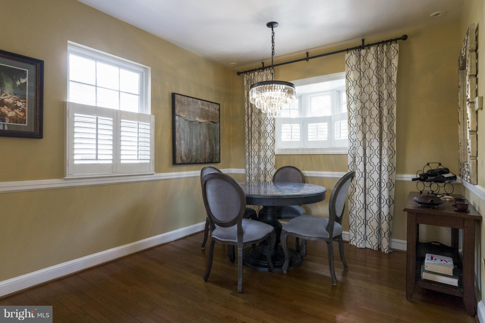9921 Rogart Road Silver Spring, MD 20901 - Photo 5 of 30 a view of a dining room with furniture window and wooden floor