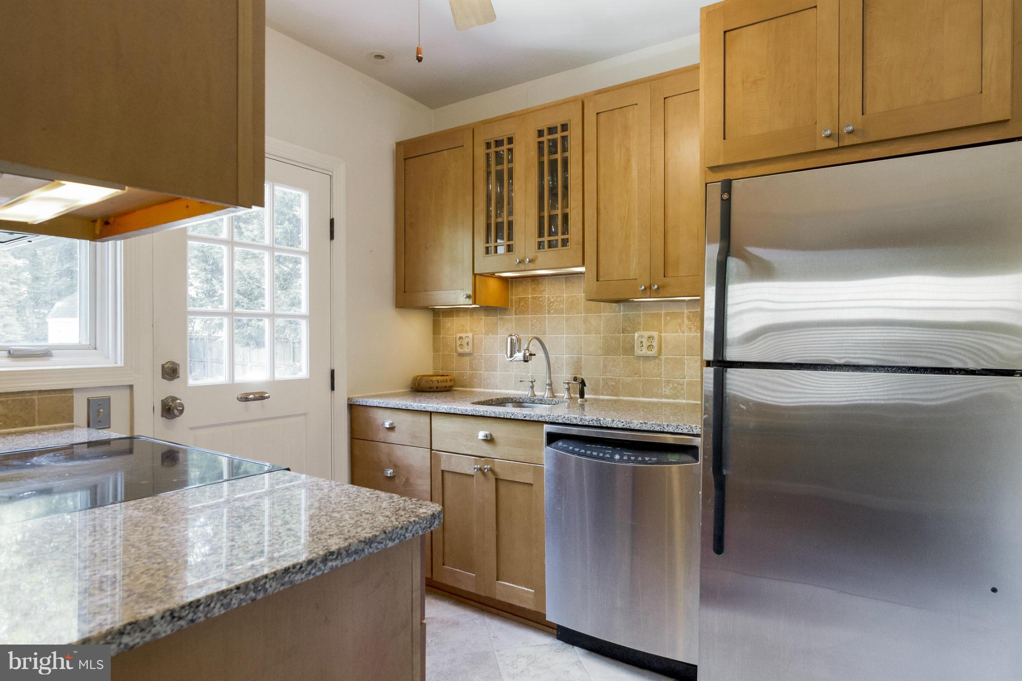 9921 Rogart Road Silver Spring, MD 20901 - Photo 7 of 30 a kitchen with stainless steel appliances granite countertop a sink stove and refrigerator