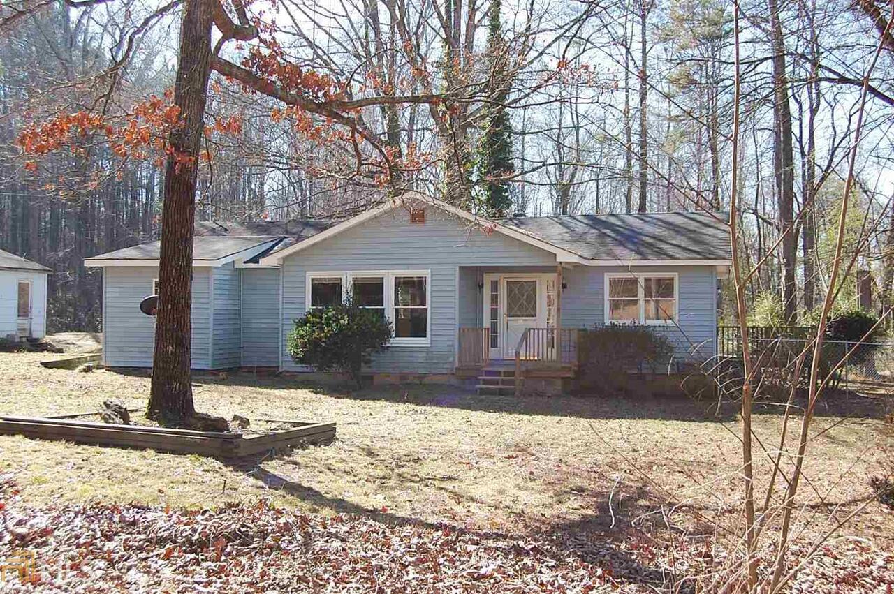 244 West Ranchette Road Temple, GA 30179 - Photo 1 of 1 a front view of a house with a yard covered in snow