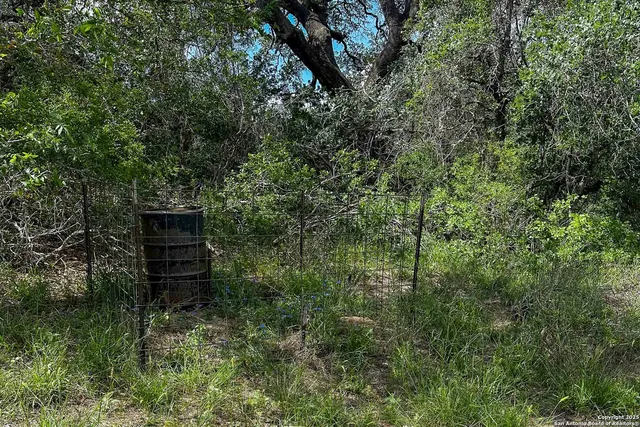 a backyard of a house with a yard and outdoor seating